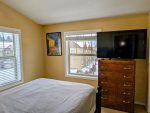 Flat screen TV and large dresser in the guest bedroom